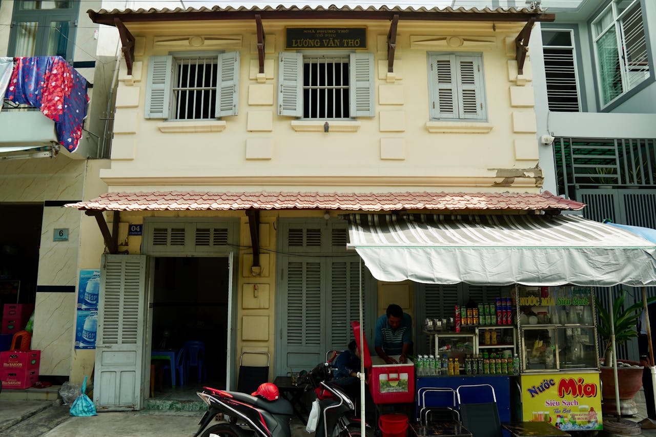 Charming street vendor stall with traditional architecture in a lively urban area, perfect for exploring local culture.