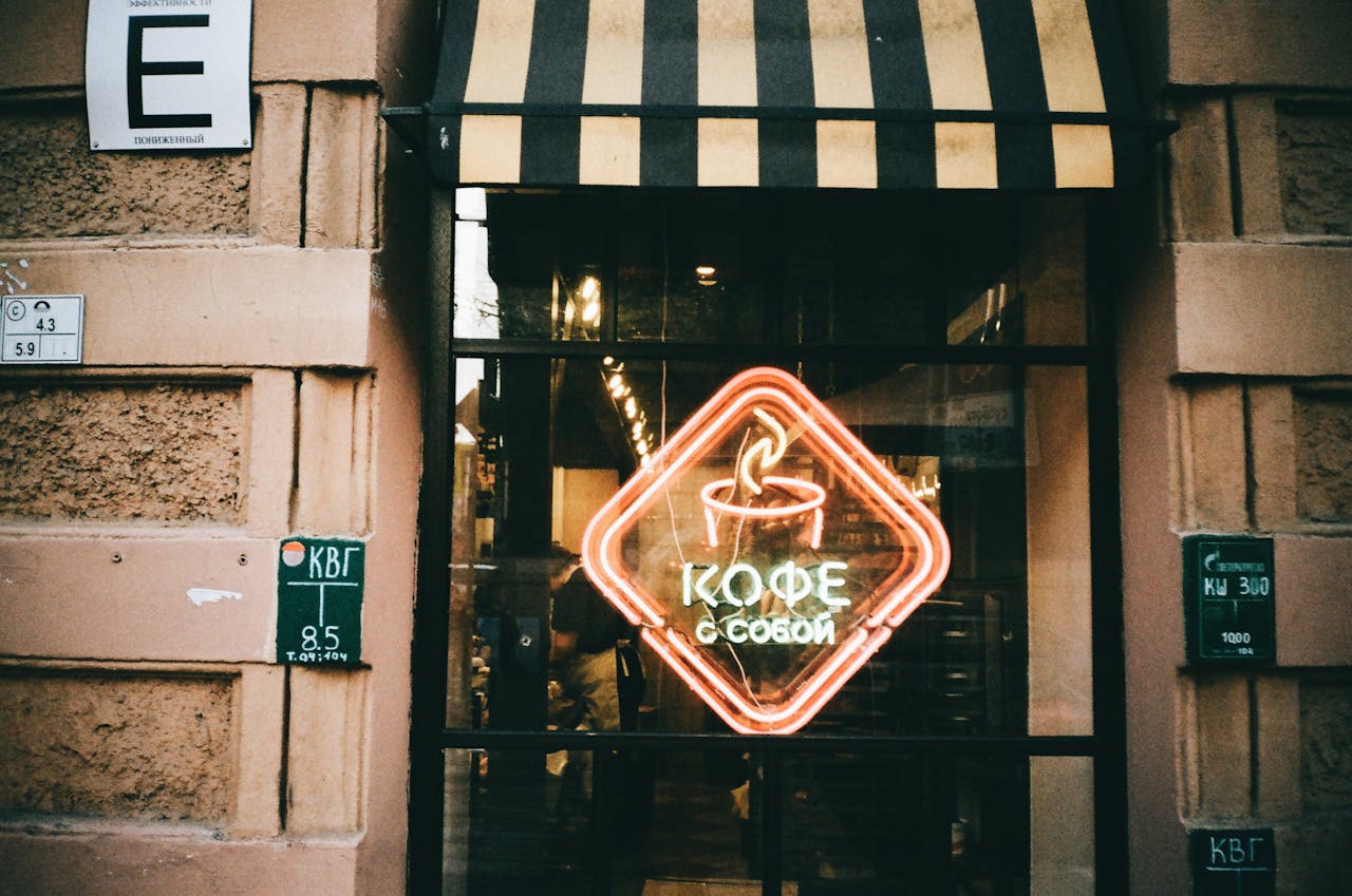 Street exterior with neon coffee sign at a cozy café in Saint Petersburg.